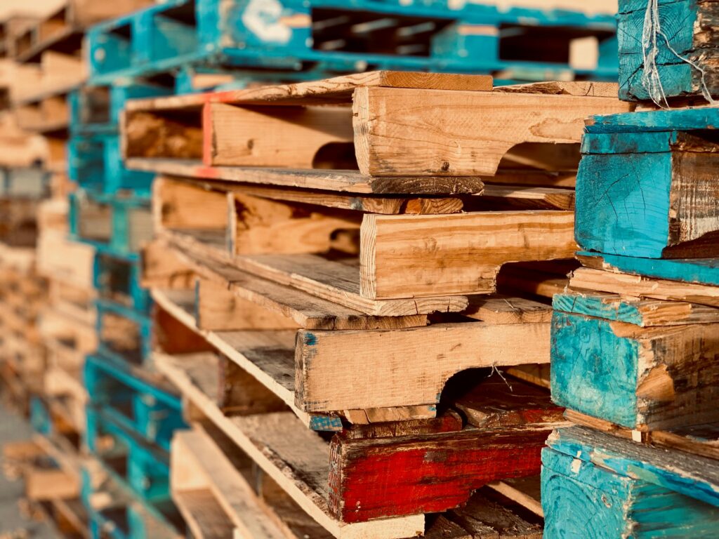 pexels photo 1684989 1684989 Close-up of colorful stacked wooden pallets in outdoor sunlight.